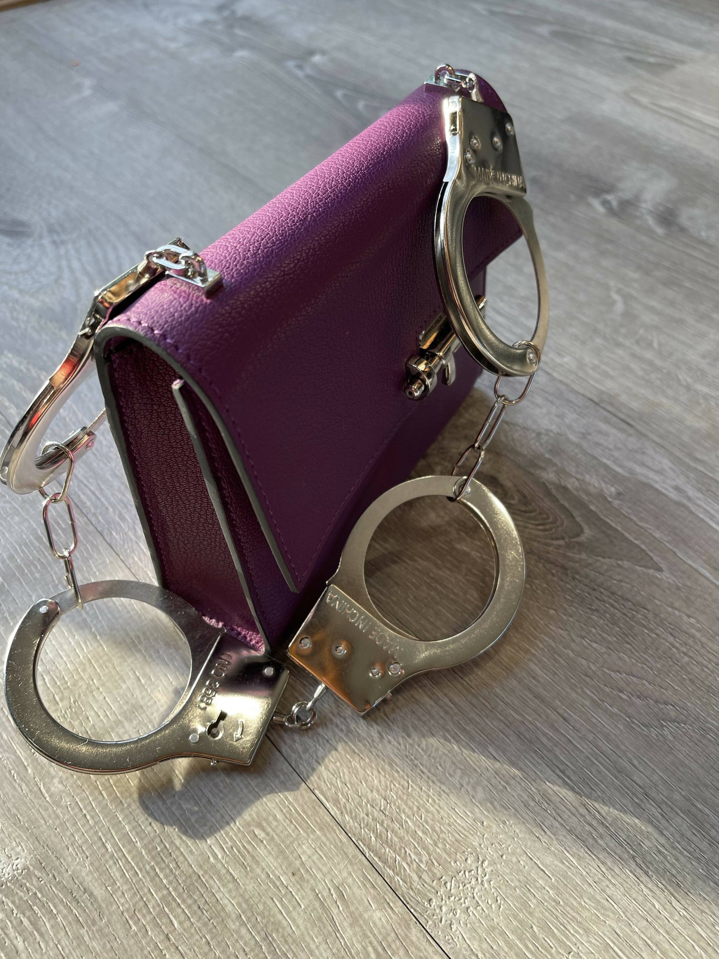 Purple Allure: Vintage-Inspired Leather Bag with Bold Handcuff Handle