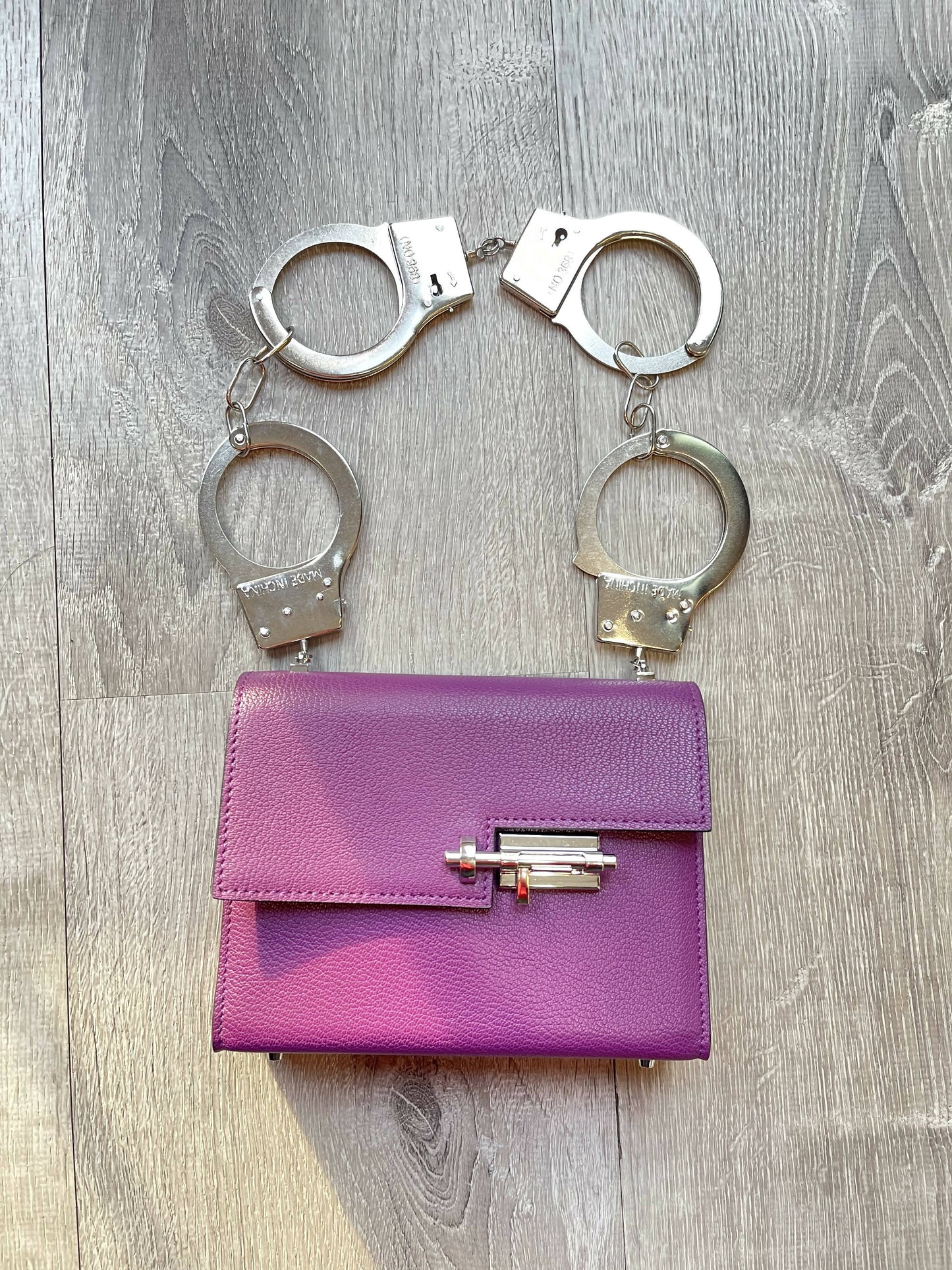 Purple Allure: Vintage-Inspired Leather Bag with Bold Handcuff Handle
