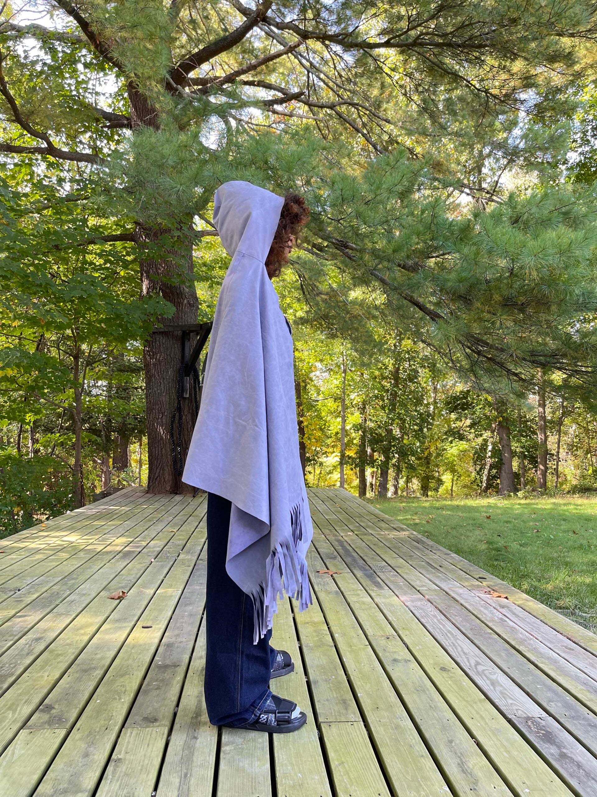 Suede backpack transforms into a hooded cloak